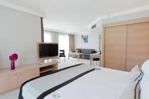 A television and/or entertainment centre at Ramada Resort by Wyndham Bodrum
