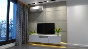 a living room with a tv on a wall at Black Line Apartment in Kraków