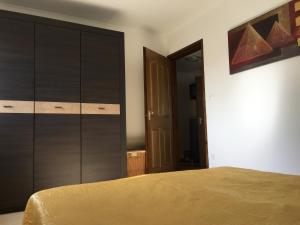 a bedroom with a bed and a large closet at Marilyn Apartman Gyenesdiás in Gyenesdiás