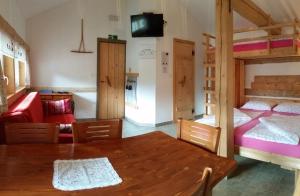a room with a dining table and two bunk beds at Apartments Čebelica in Bohinj