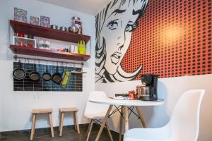 a dining room with a table and stools at Utopia Home Alameda in Seville