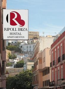 a street sign on a pole on a city street at Hostal Ripoll Ibiza in Ibiza Town