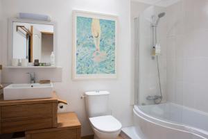 a bathroom with a toilet and a sink and a bath tub at La Colline des Renards in Locmaria-Berrien +22 photos