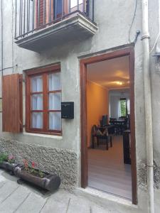 eine Tür zu einem Gebäude mit einem Balkon und einer Terrasse in der Unterkunft Casa Ponet in Valencia de Aneu