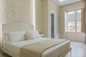 トロペアにあるTownhouse Tropeaの白いベッドルーム(大型ベッド1台、窓付)