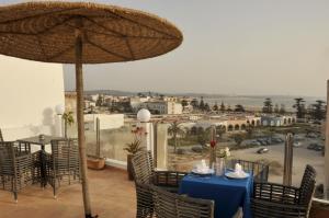 a table and chairs with a view of a city at Hotel Riad Ben Atar in Essaouira
