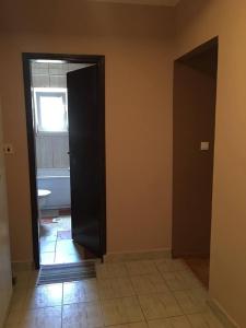 an empty room with a door leading to a bathroom at Paladium Apartment in Budva
