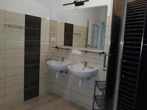 a bathroom with two sinks and a mirror at Domek Salent in Mrągowo +23 photos