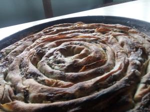 a pie sitting in a pan on a table at Bungalows Old Town in Visoko