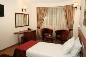 A bed or beds in a room at Favorit Hotel