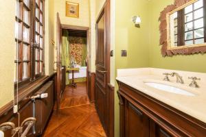 a bathroom with a sink and a mirror at La Maison Des Vieux Logis in Rouen