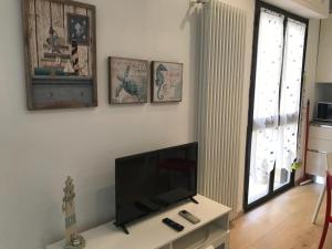 a living room with a flat screen tv on a wall at Casa Celeste in Viareggio