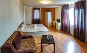 a living room with a couch and a table at Hotel West in Blagoevgrad