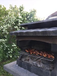 a brick oven with chickens cooking on it at Arina Villa in Hévíz