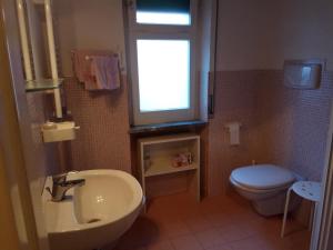 a bathroom with a sink and a toilet and a window at Emmevvì in Tropea +92 photos