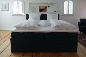 a bed with white sheets and pillows in a bedroom at Fachwerkhaus Maximilian in Speyer