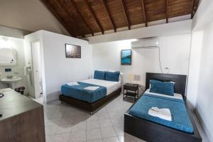 Ένα ή περισσότερα κρεβάτια σε δωμάτιο στο Sunset Hotel
