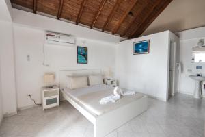 Ένα ή περισσότερα κρεβάτια σε δωμάτιο στο Sunset Hotel