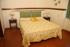 a bedroom with a bed with a yellow pillow on it at Il Casolare in Penna +85 photos