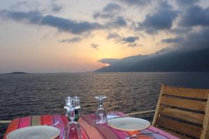 a table with two plates on top of the ocean at Mandalina Suites in Kaş