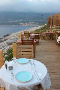 a white table with blue plates on a deck at Mandalina Suites in Kaş