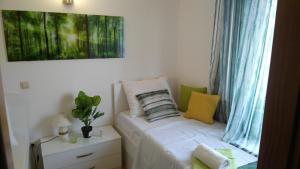 a small bed in a room with a window at Apartments Zunic in Trogir