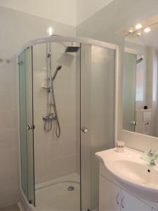 a bathroom with a shower and a sink at Apartment Cindy in Lovran