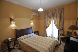 Cama ou camas em um quarto em Hotel Kalloni