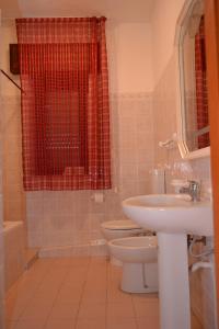 a bathroom with a toilet and a sink at B&B Jolly house Bolognetta in Bolognetta