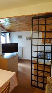 a room with a room with a bunk bed and a kitchen at Residence Hotel Montechiara in Baselga di Pinè