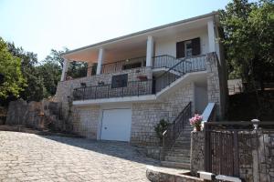 a house with a garage and a balcony at La Dimora Del Cuore in Monopoli