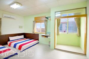 Łóżko lub łóżka w pokoju w obiekcie Xiang Ting Homestay