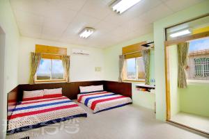 Łóżko lub łóżka w pokoju w obiekcie Xiang Ting Homestay