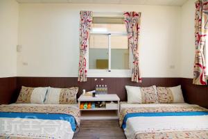 Łóżko lub łóżka w pokoju w obiekcie Xiang Ting Homestay