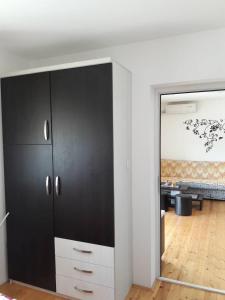 a large black cabinet in a room with a bedroom at Alex Banja in Soko Banja