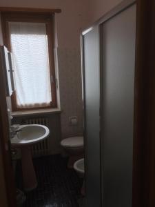 a bathroom with a toilet and a sink and a shower at Casa Salice in Racconigi