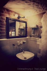 a bathroom with a sink and a mirror at Apartment Grubenhaus20 in Freiberg +81 photos
