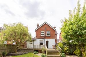 a house with a fence and stairs in front of it at Executive Victorian House in Andover