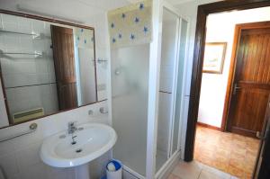 a bathroom with a sink and a shower with a mirror at Villino Il Ginepro in Cannigione +60 photos