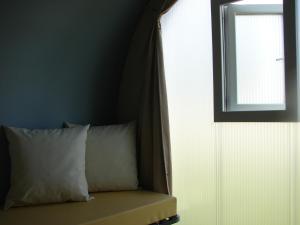 a bedroom with a bed with a window and a pillow at Camping Au Coeur de Vendome in Vendôme