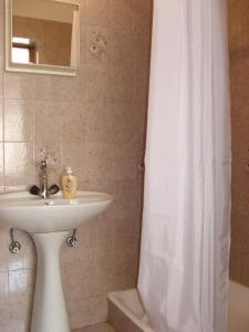 a bathroom with a sink and a shower curtain at Apartments&Rooms Milka in Starigrad-Paklenica