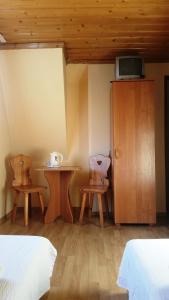 a bedroom with two chairs and a table and a cabinet at Janosik in Bustryk