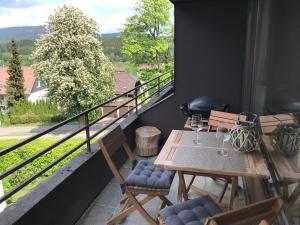a balcony with a table and chairs with a view at Chalet am Hasselkopf in Braunlage