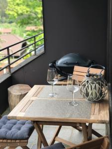 a wooden table with two wine glasses and a purse at Chalet am Hasselkopf in Braunlage