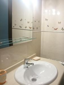 a bathroom with a sink and a mirror at "Ventana del Guadalquivir " in Baeza