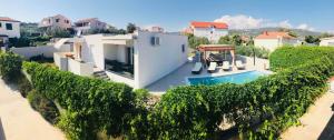 a villa with a swimming pool and a house at Holiday home Marina in Sevid