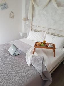 a bedroom with a bed with a tray of food on it at Terry's House in Nuoro