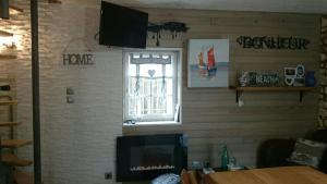 a living room with a fireplace and a window at Chez Isa in Yport