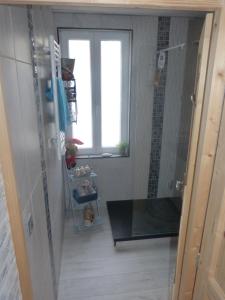 a bathroom with a shower with a window and a glass door at Chez Isa in Yport +33 photos