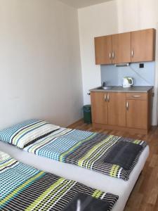 A bed or beds in a room at Šariš rooms